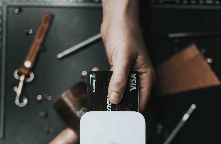 man entering card into card machine and making a sale