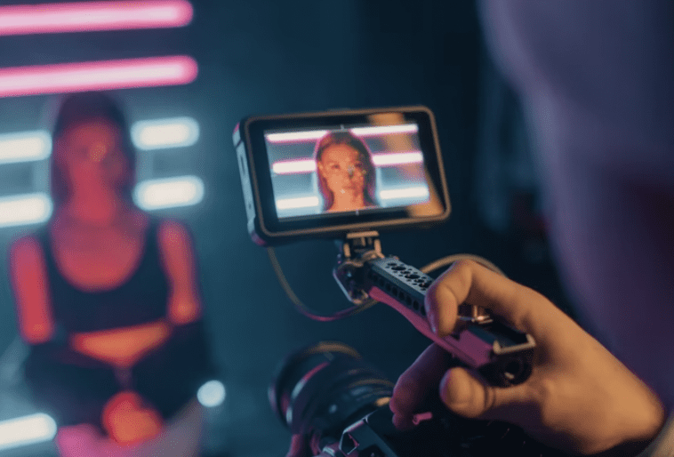 man filming close up of woman for video portfolios